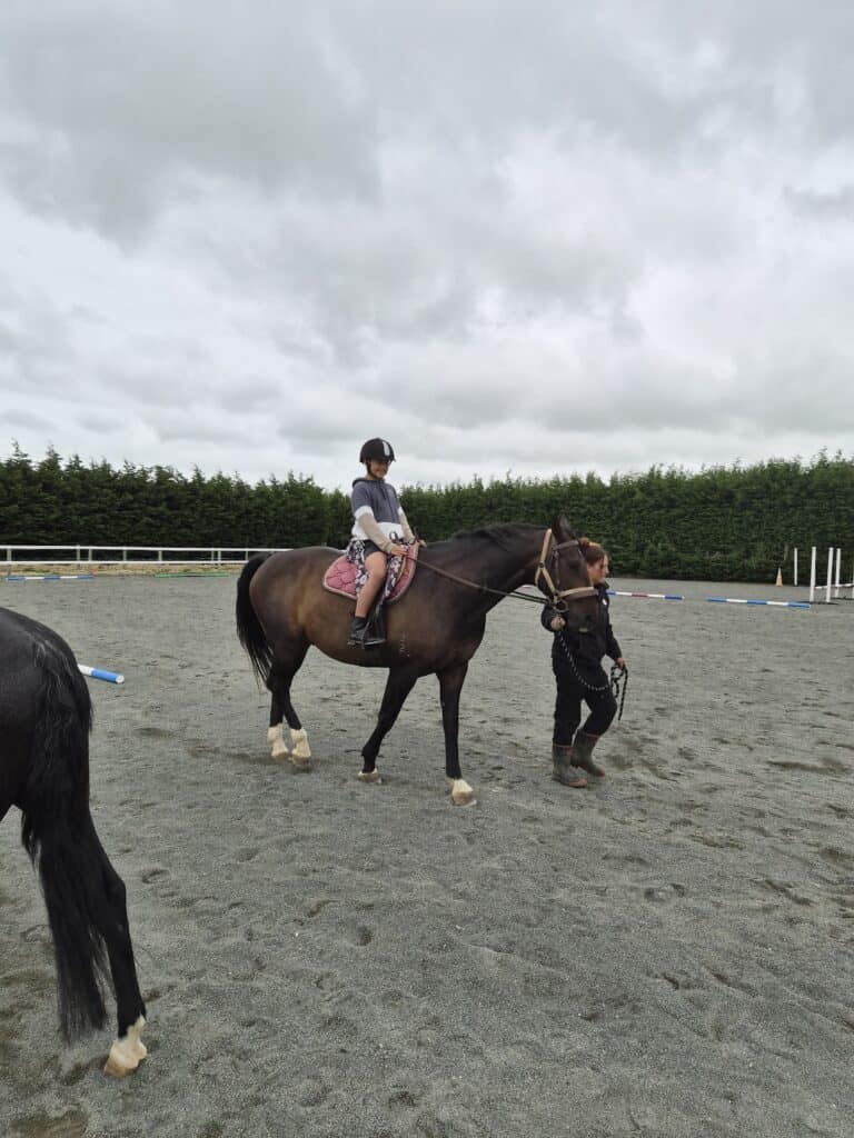 Child riding a horse at Reigning Downs Hauora Centre in New Zealand.